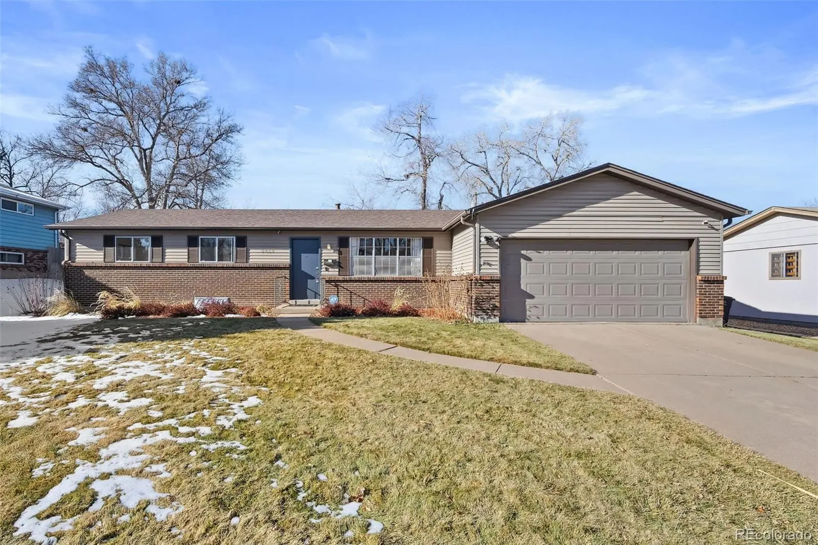 A front view of a house with a yard and garage at 3417 South Chester Court
