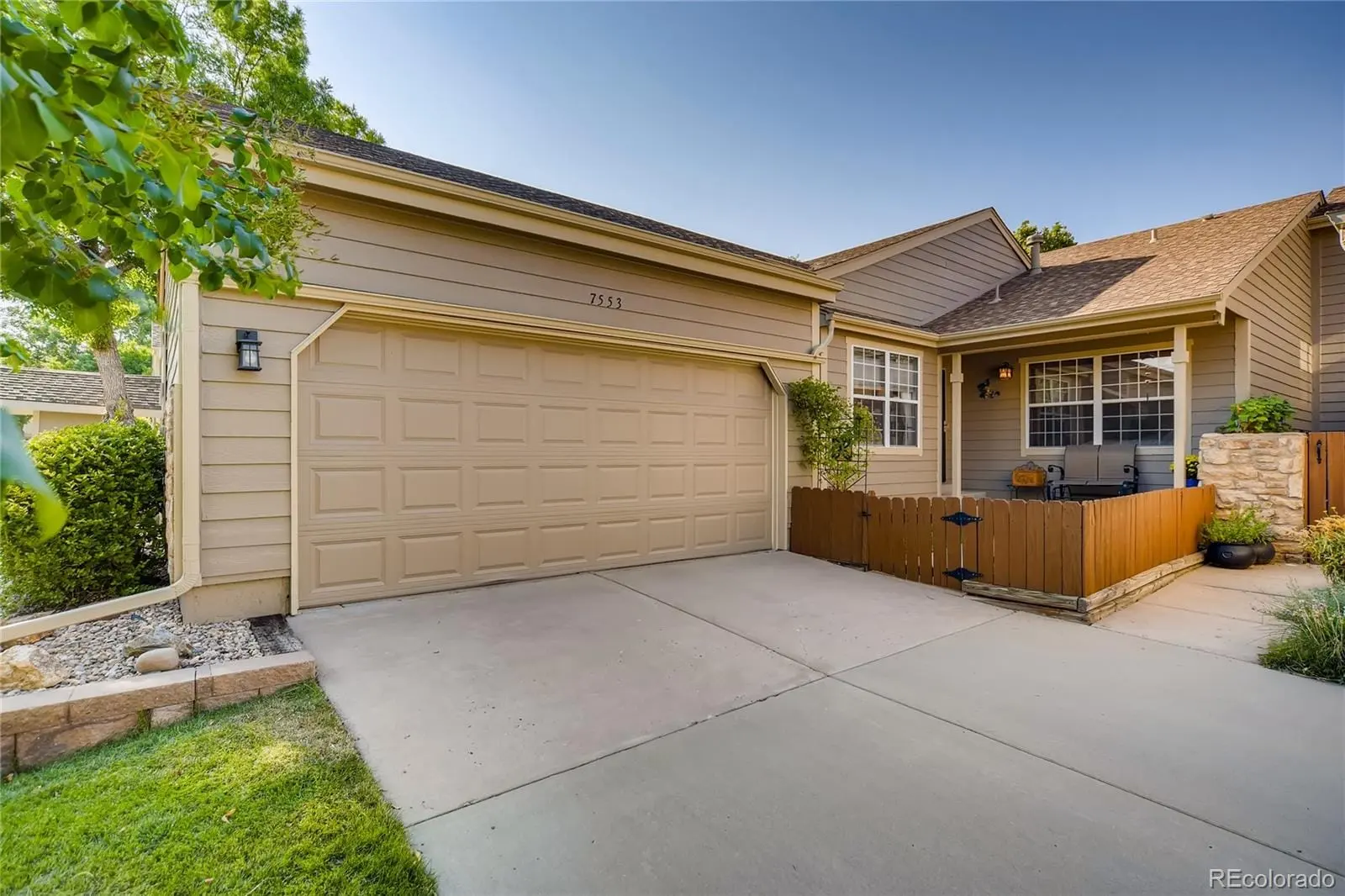 A view of a house with a backyard and porch at 7553 West Euclid Drive