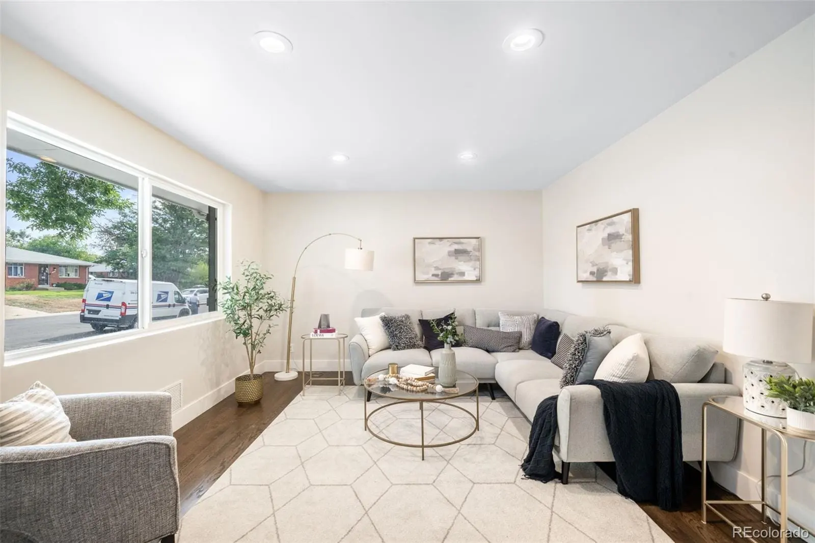 A living room with furniture and a large window at 7901 Maria Street