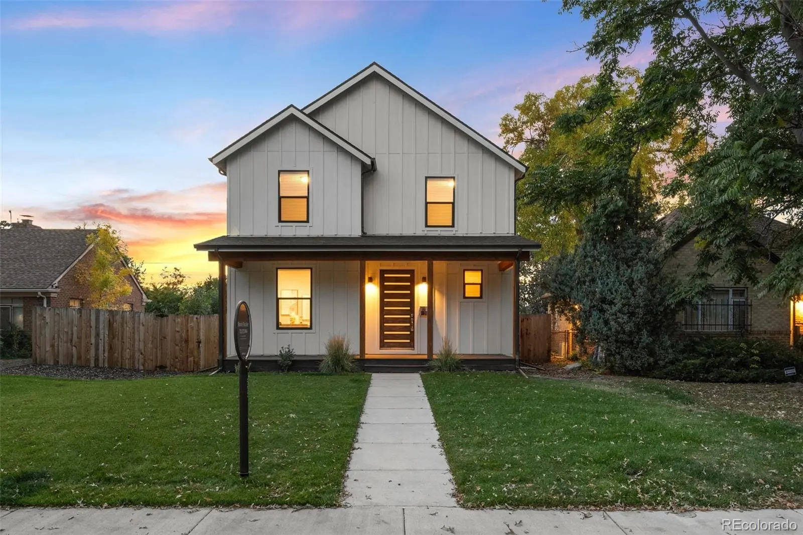 A front view of a house with a yard and garage at 2865 Holly Street