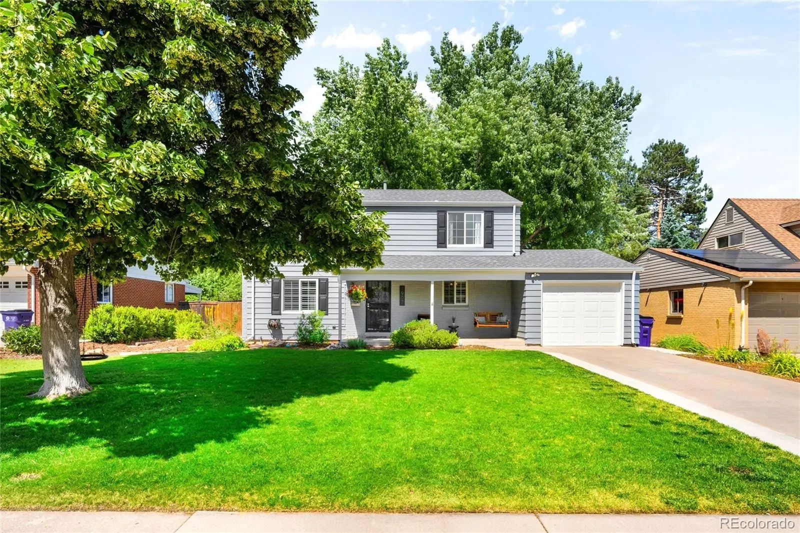 A view of a house with a yard and sitting area at 1907 South Leyden Street
