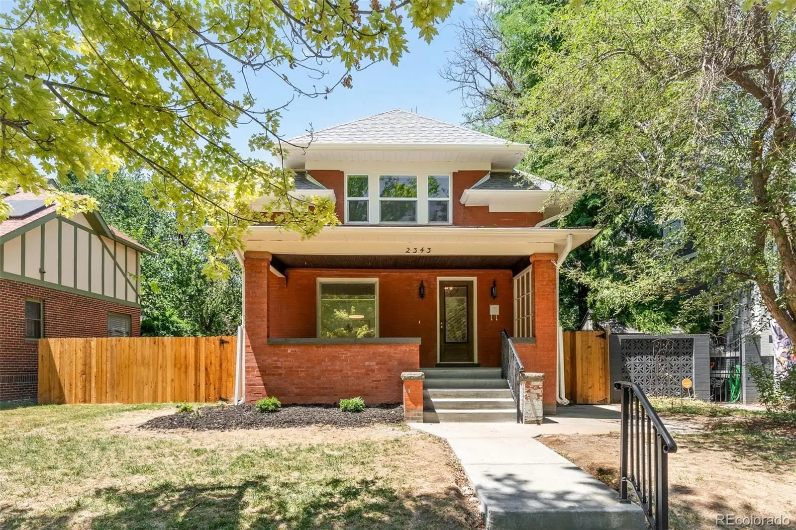 A view of a house with a yard at 2343 Dahlia Street