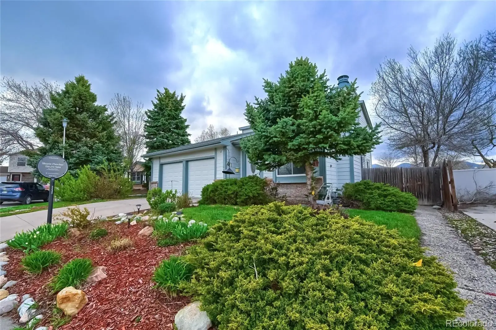A view of a house with a garden and trees at 5803 South Miller Street