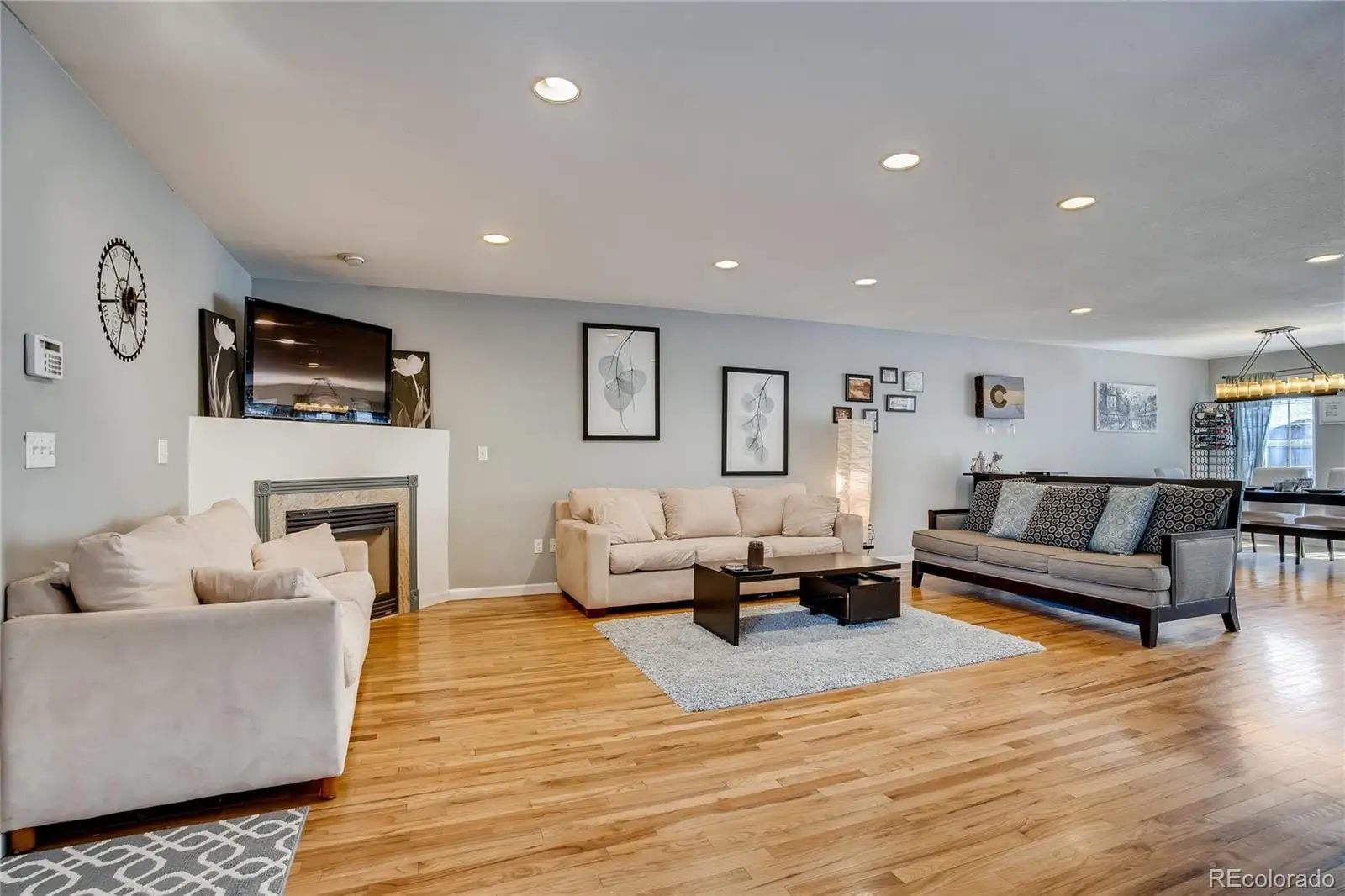 A living room with furniture a fireplace and a flat screen tv at 1126 West 10th Avenue