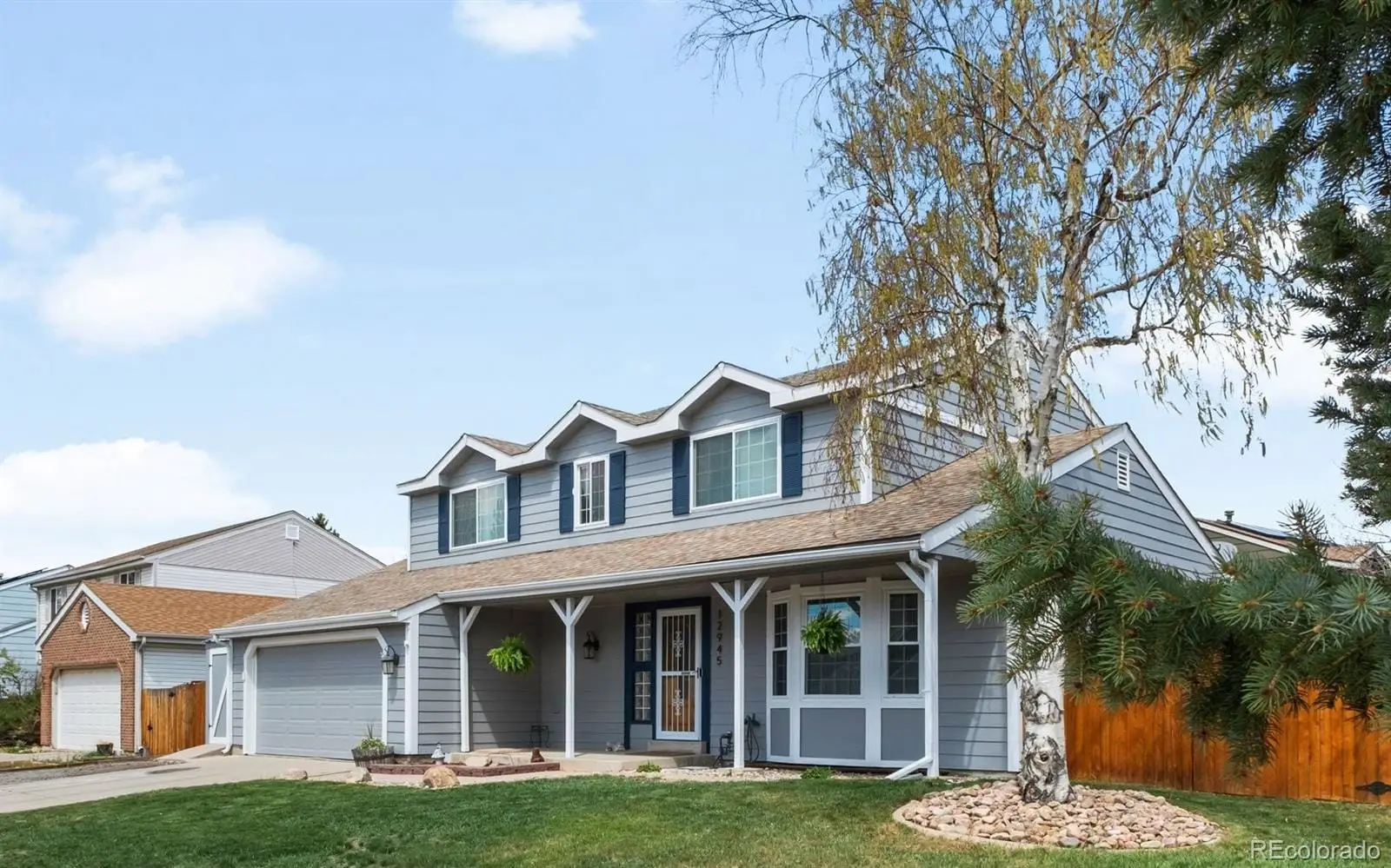 Front view of a brick house with a yard at 12945 East Colorado Avenue