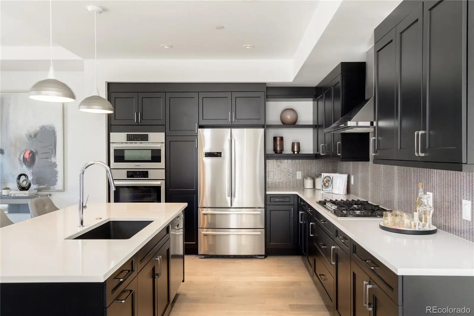 A kitchen with stainless steel appliances a sink stove and refrigerator at 274 South Monroe Street, Unit 1002