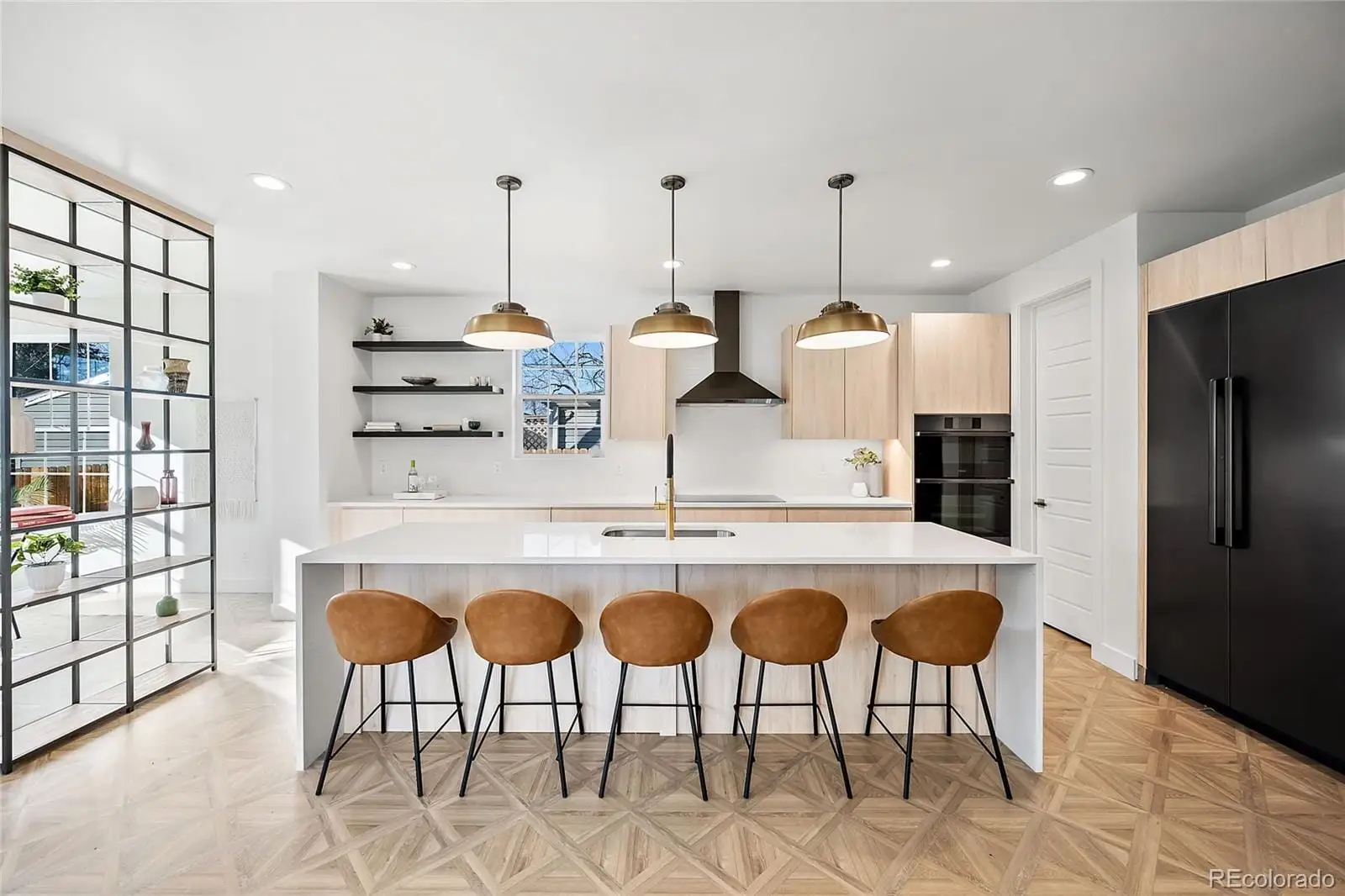 A kitchen with stainless steel appliances granite countertop a sink and a refrigerator at 3217 South Elm Street