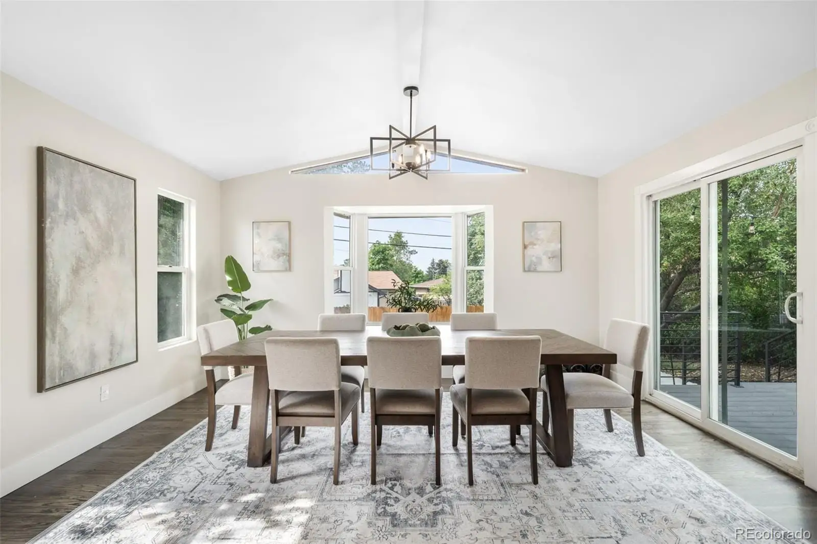 A view of a dining room with furniture window and outside view at 7901 Maria Street