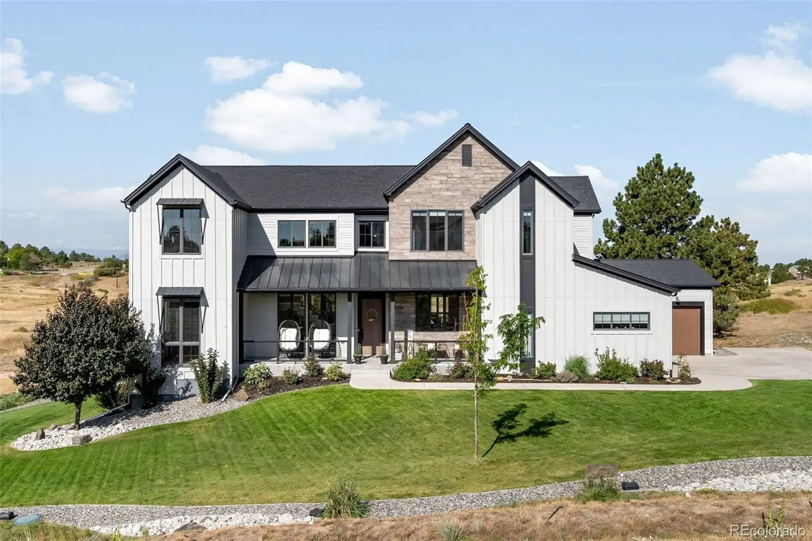 A front view of house with yard and green space at 8203 Merryvale Trail