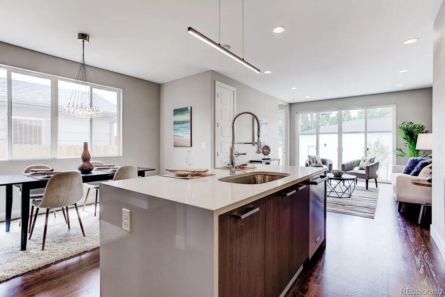 A open kitchen with stainless steel appliances granite countertop a table chairs stove and sink at 2851 South Cherokee Street