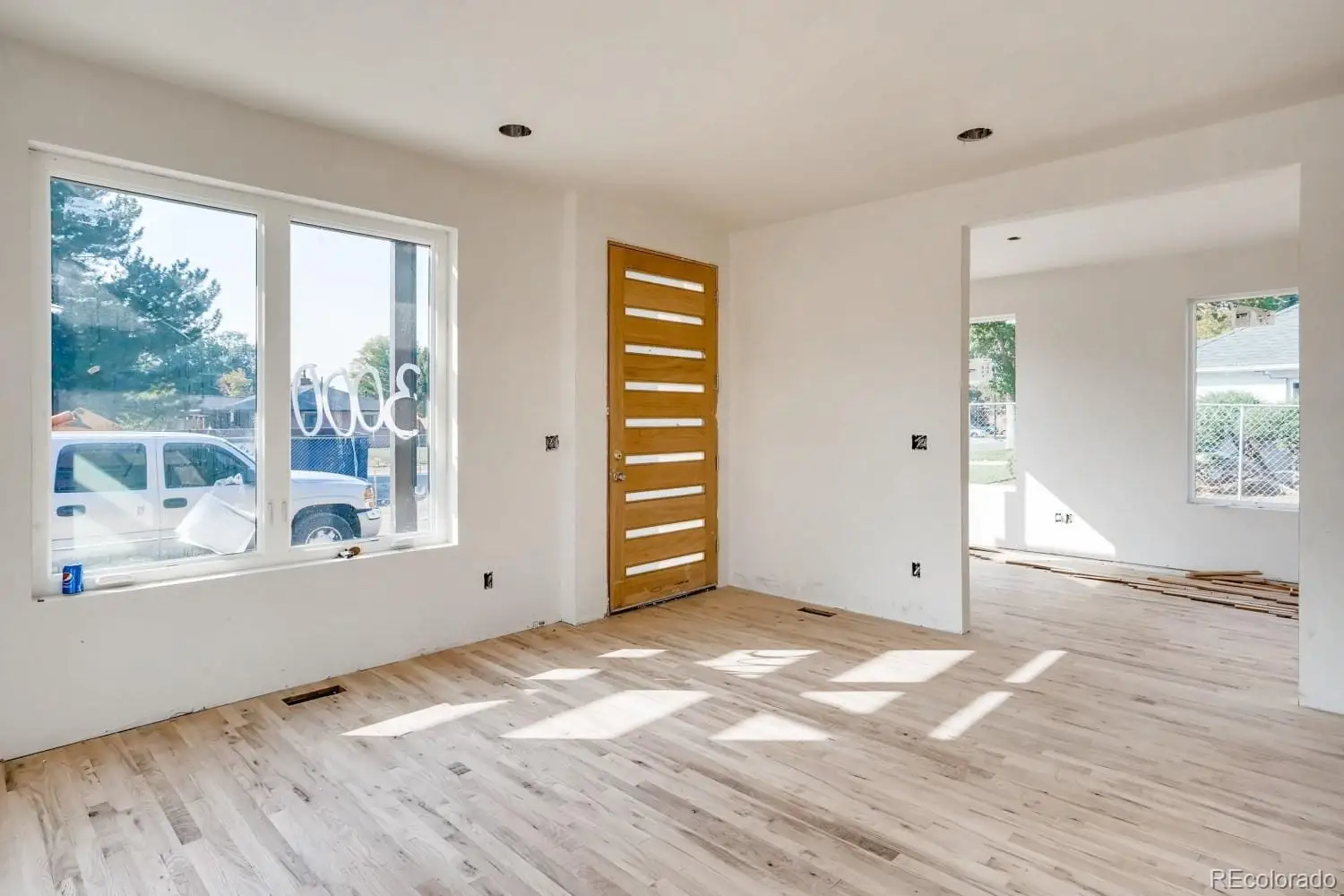 A view of empty room with wooden floor and fan at 1001 Newport Street