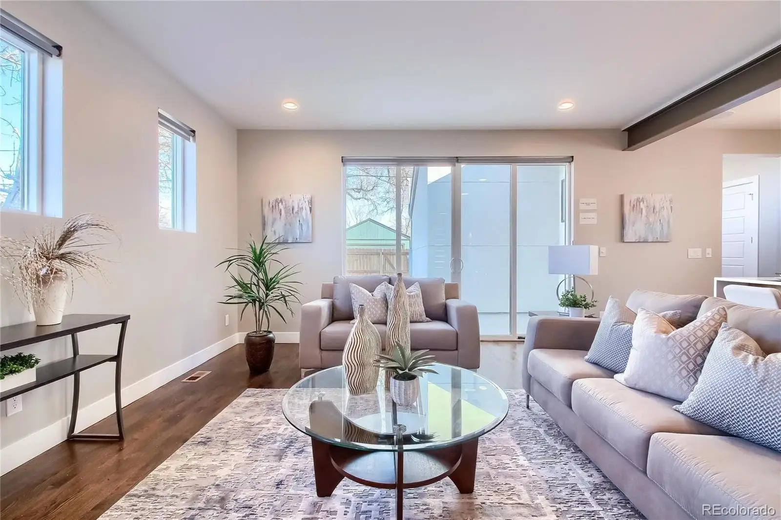 A living room with furniture potted plant and windows at 3000 Glencoe Street
