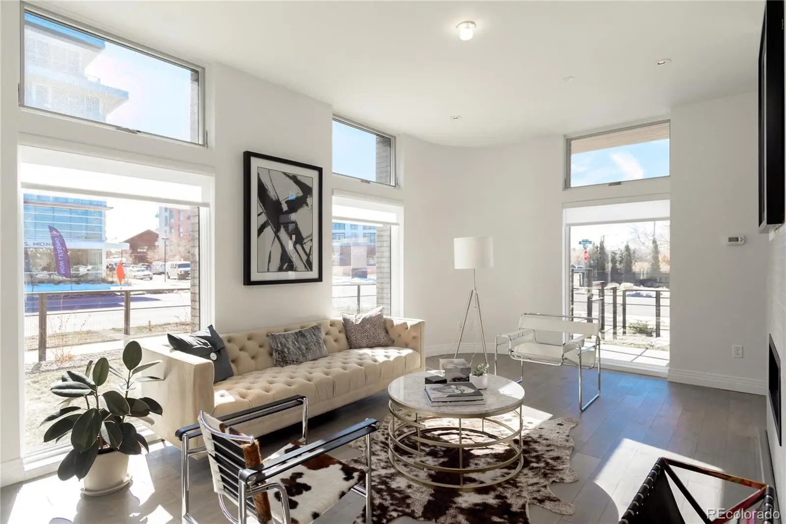 A living room with furniture and a large window at 274 South Monroe Street, Unit 1002