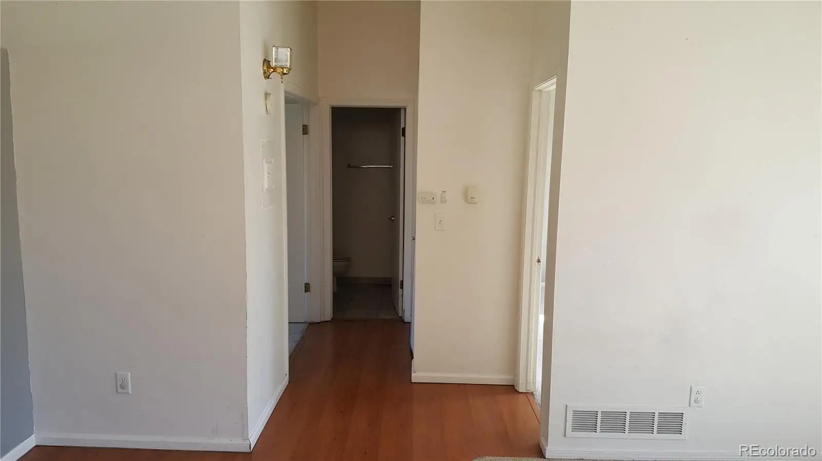 A view of a hallway with wooden floor at 17155 East Chenango Avenue, Unit A