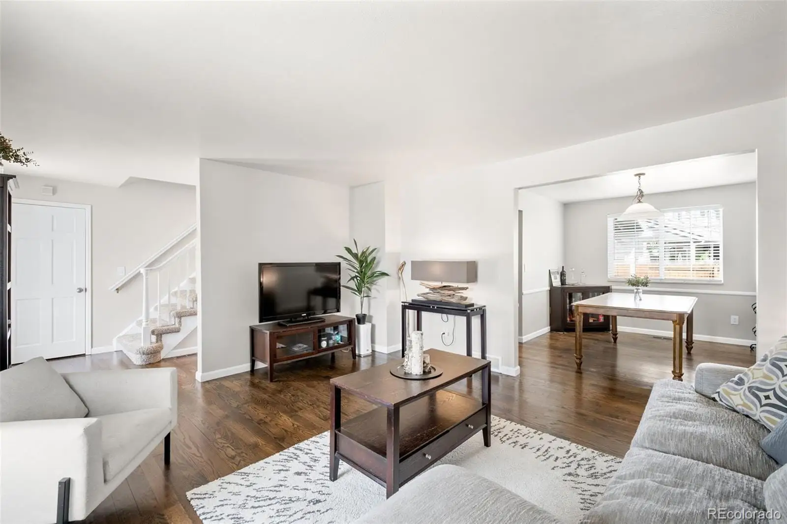 A living room with furniture wooden floor and a flat screen tv at 12945 East Colorado Avenue