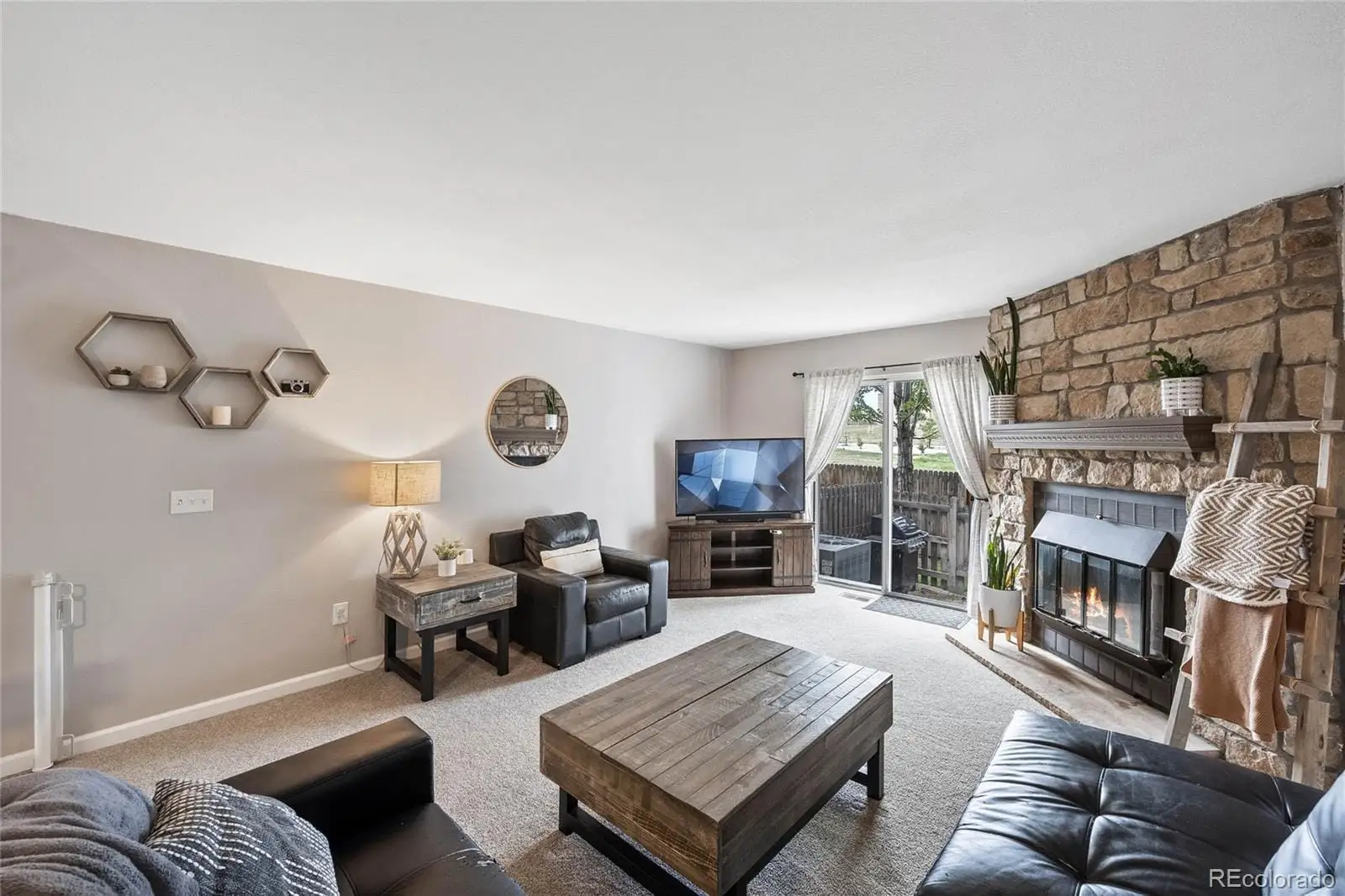 A living room with furniture and a fireplace at 8135 South Fillmore Circle