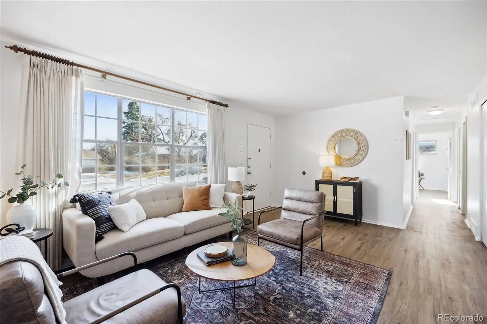 A living room with furniture and a large window at 3417 South Chester Court