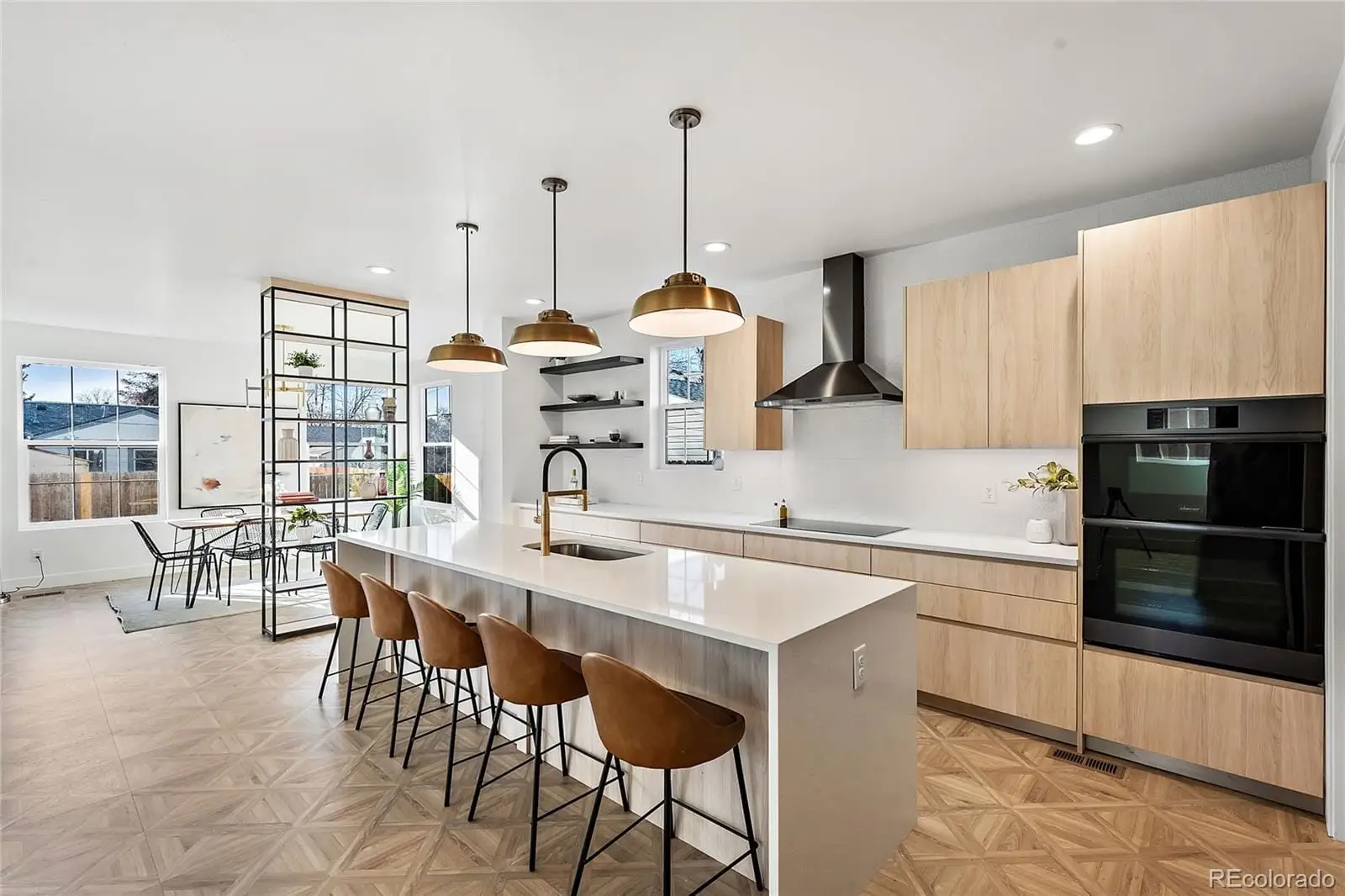 A kitchen with stainless steel appliances granite countertop a stove top oven a sink a counter space and cabinets at 3217 South Elm Street