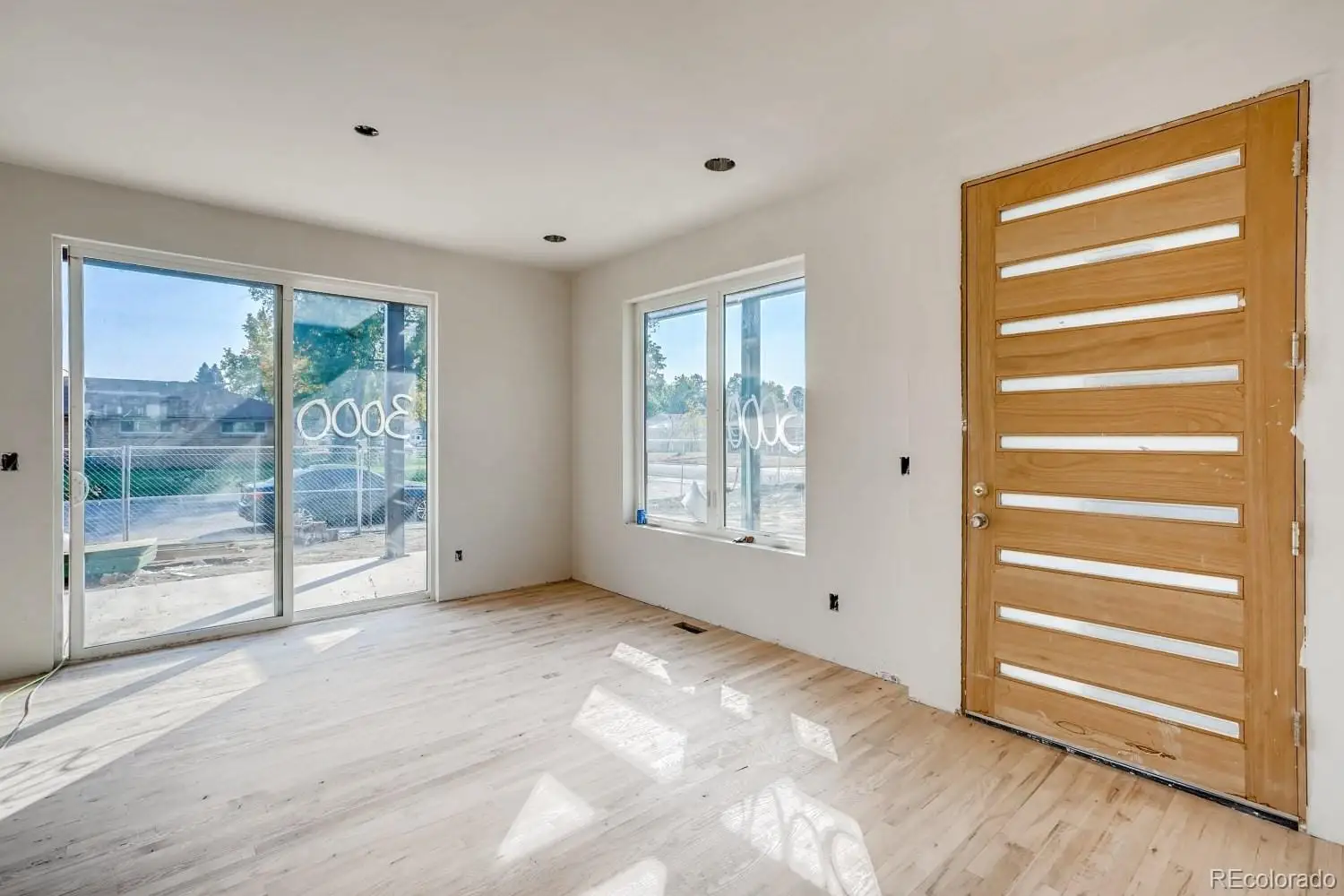 A view of empty room with wooden floor and fan at 1001 Newport Street