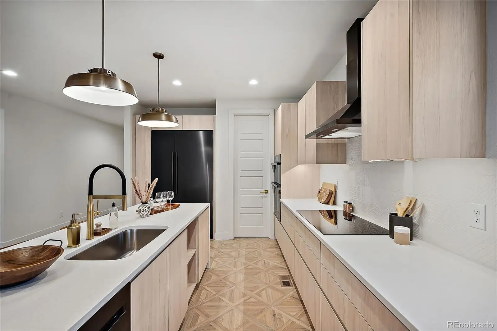 A kitchen with stainless steel appliances a sink a stove and refrigerator at 1076 Jasmine Street