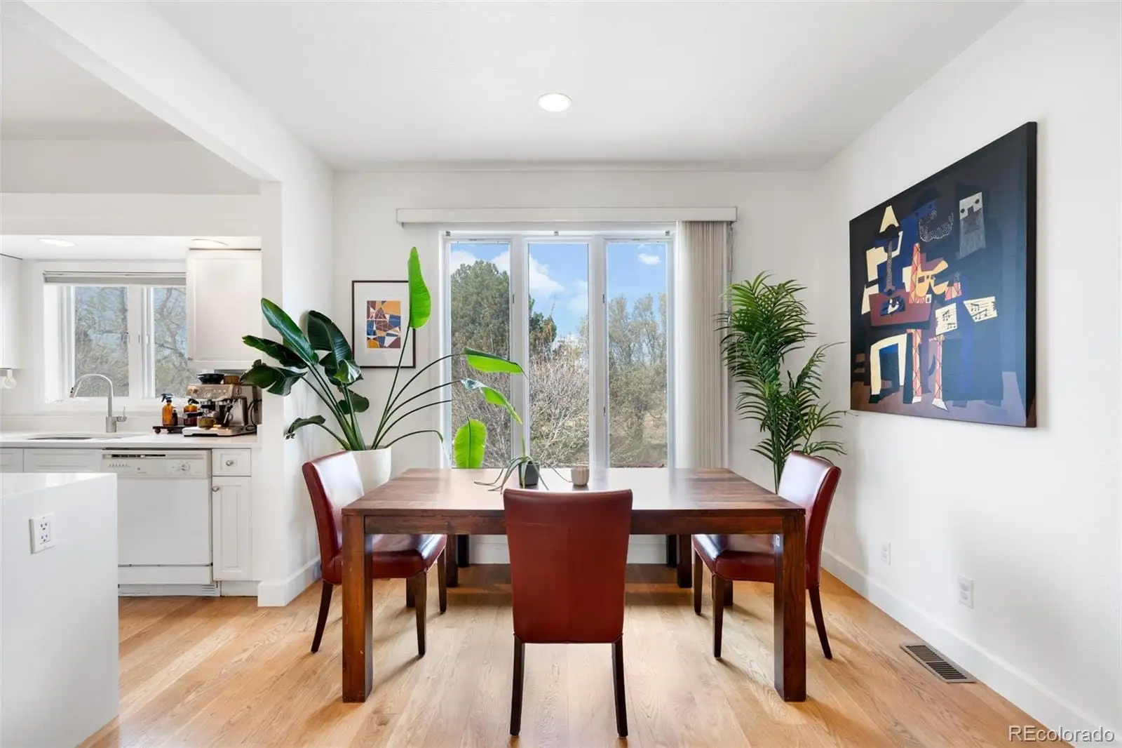 A view of a dining room with furniture window and wooden floor at 234 South Madison Street, Unit H