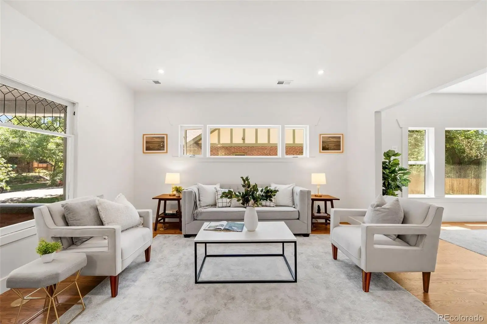 A living room with furniture and a large window at 2343 Dahlia Street