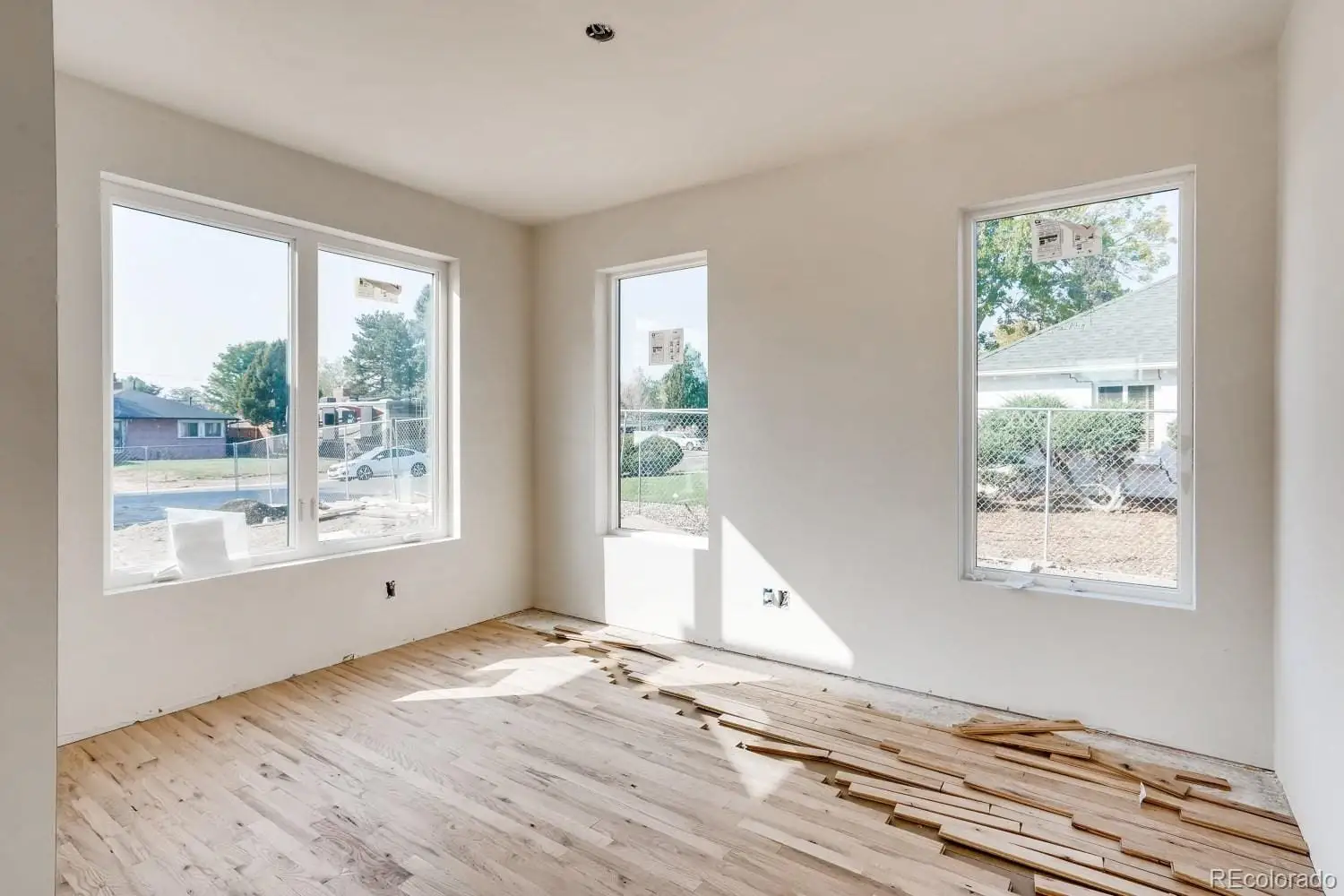 A view of an empty room with wooden floor and a window at 1001 Newport Street