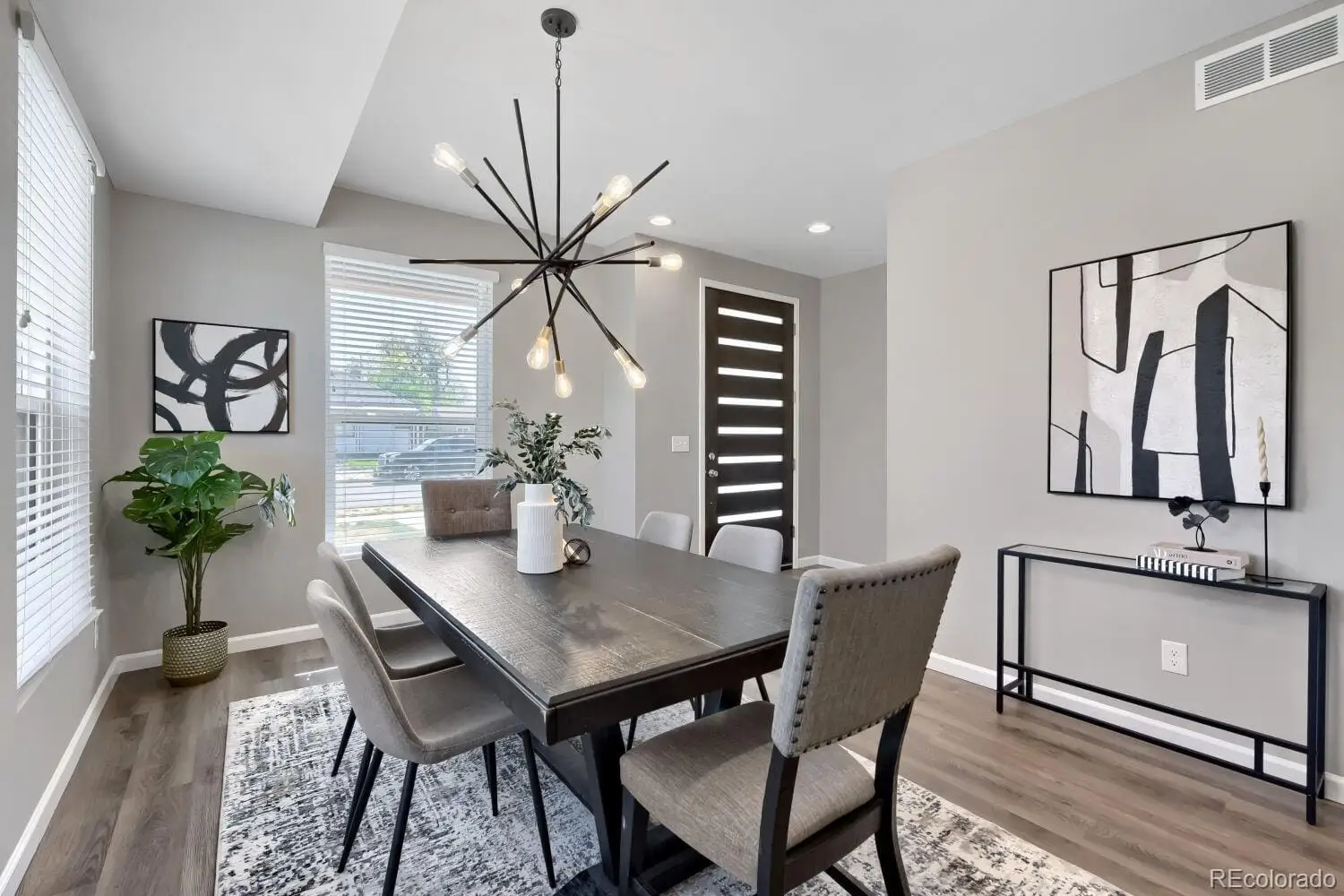A view of a dining room with furniture and a potted plant at 3007 South Cherokee Street