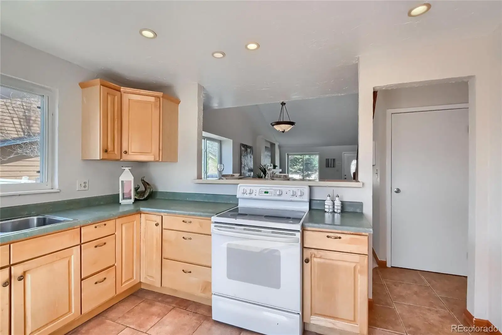 A kitchen with granite countertop white cabinets and white appliances at 5803 South Miller Street