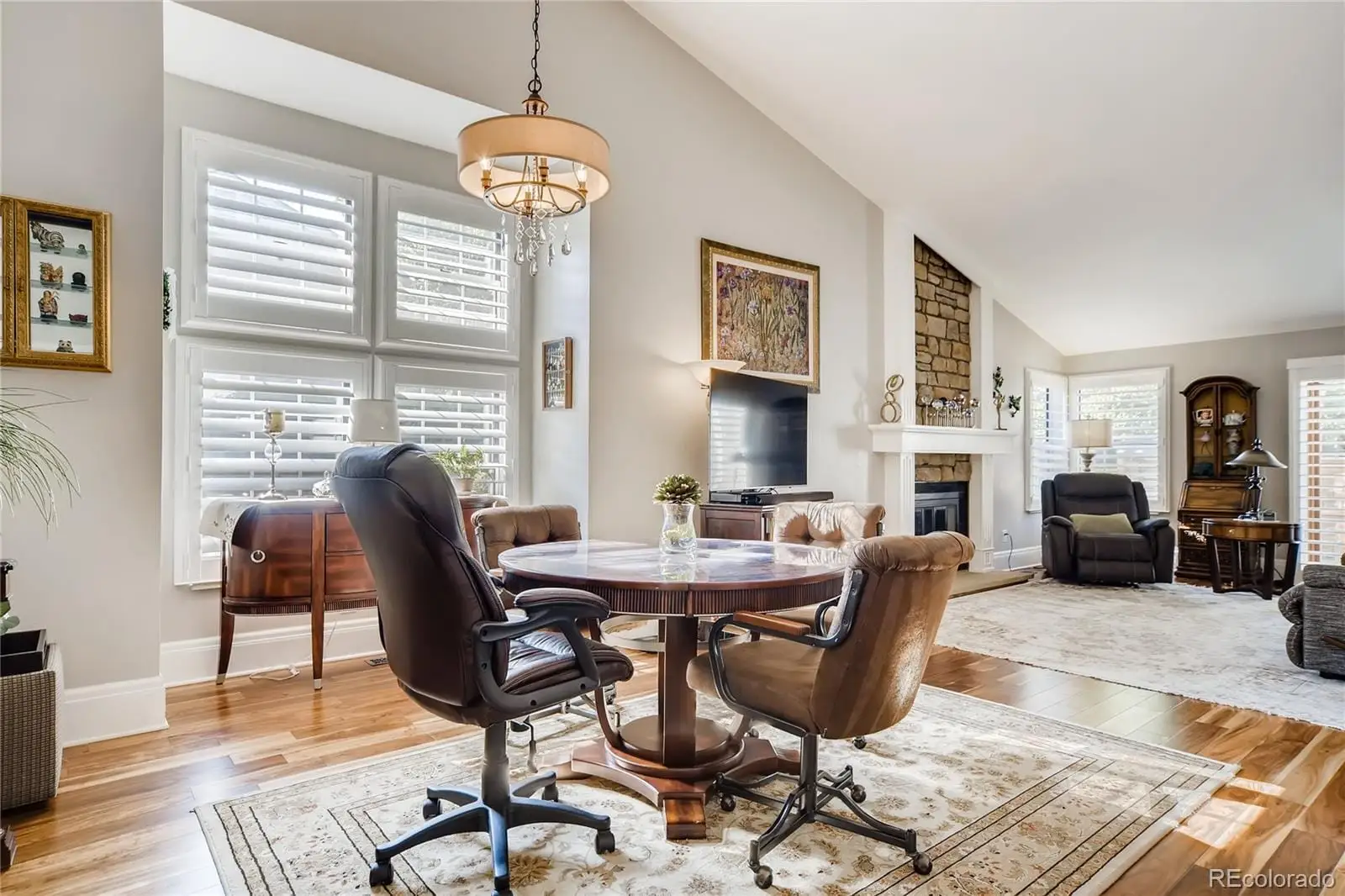 A view of a dining room with furniture window and wooden floor at 7553 West Euclid Drive