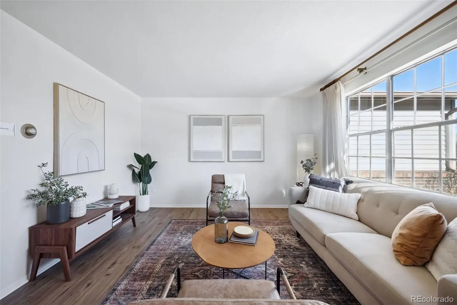 A living room with furniture potted plant and window at 3417 South Chester Court