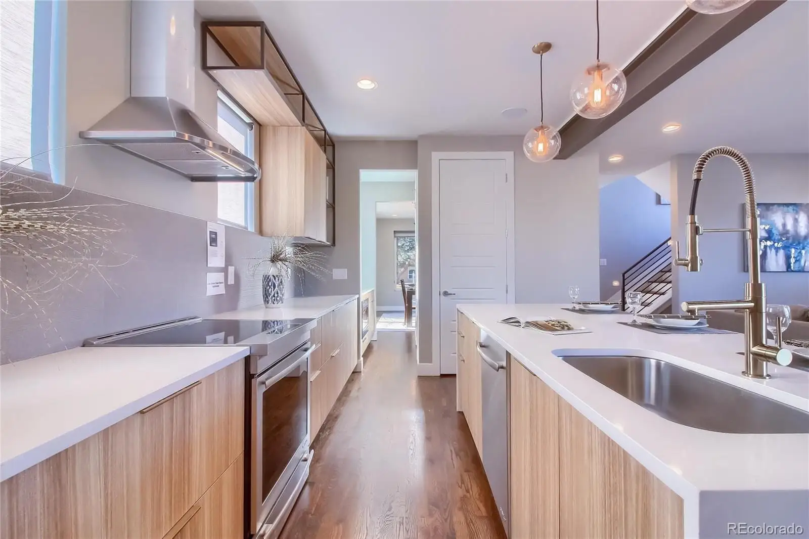 A kitchen with a sink stove and cabinets at 3000 Glencoe Street
