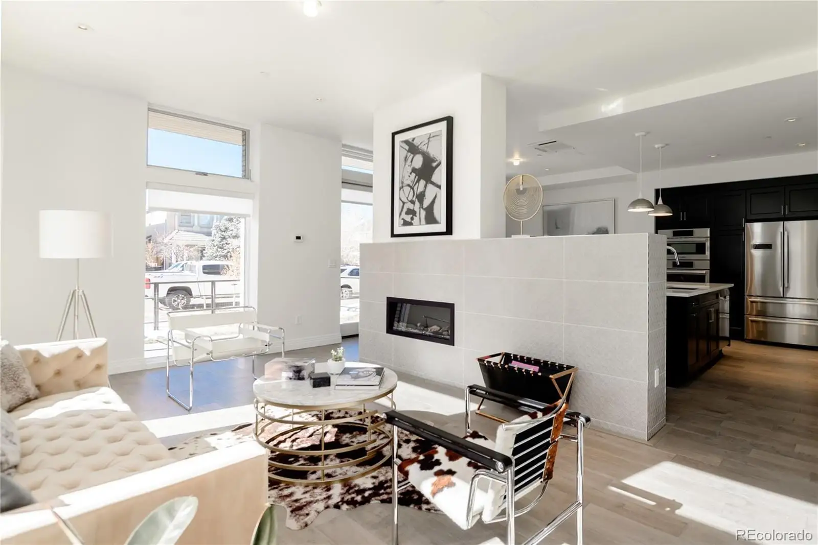 A living room with furniture and a fireplace at 274 South Monroe Street, Unit 1002