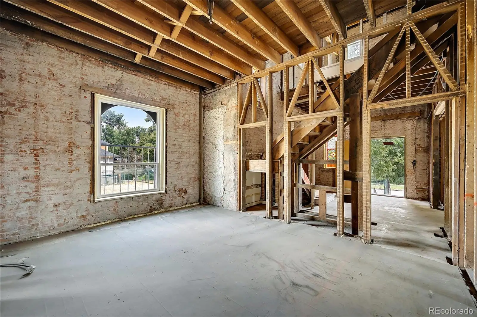 A view of an empty room with wooden floor and a window at 2511 North Gaylord Street