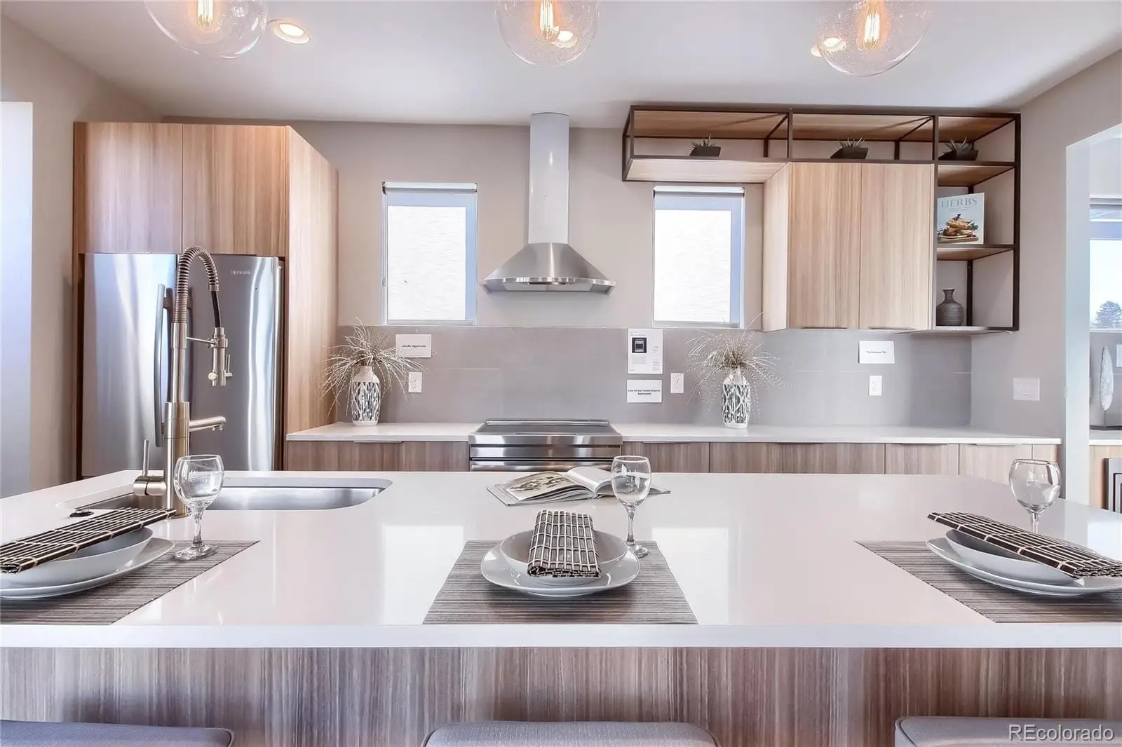 A kitchen with stainless steel appliances a sink and a stove at 3000 Glencoe Street