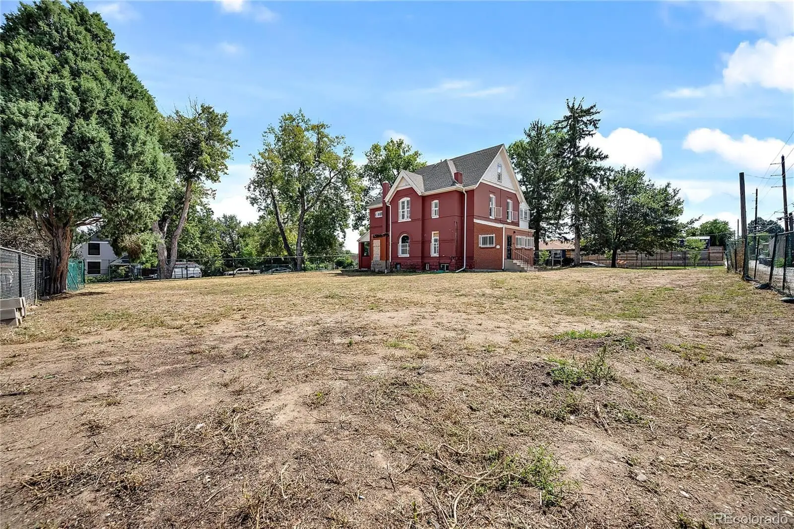 A big yard with large trees and a building at 2521 North Gaylord Street