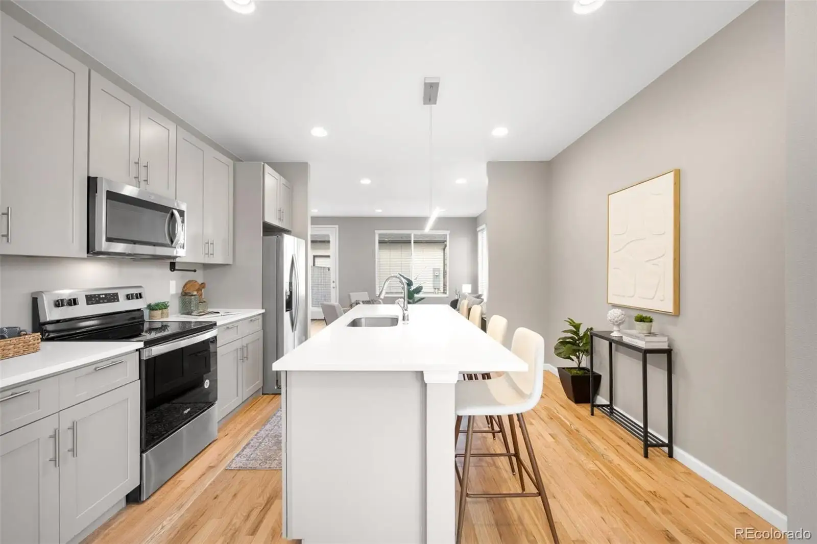 A large kitchen with stainless steel appliances kitchen island granite countertop a sink and cabinets at 1039 Julian Street