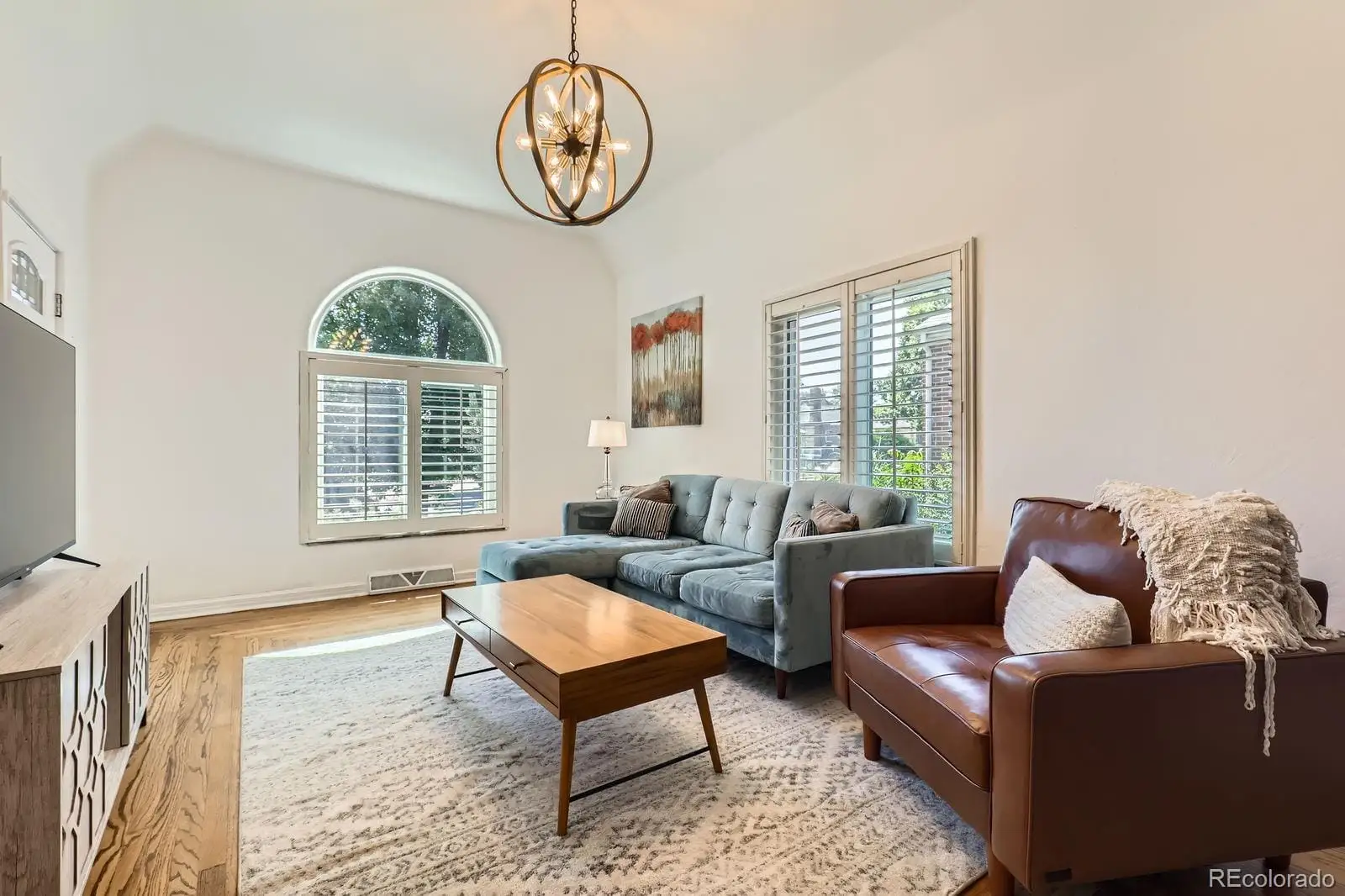 A living room with furniture a rug and a window at 3065 Clermont Street