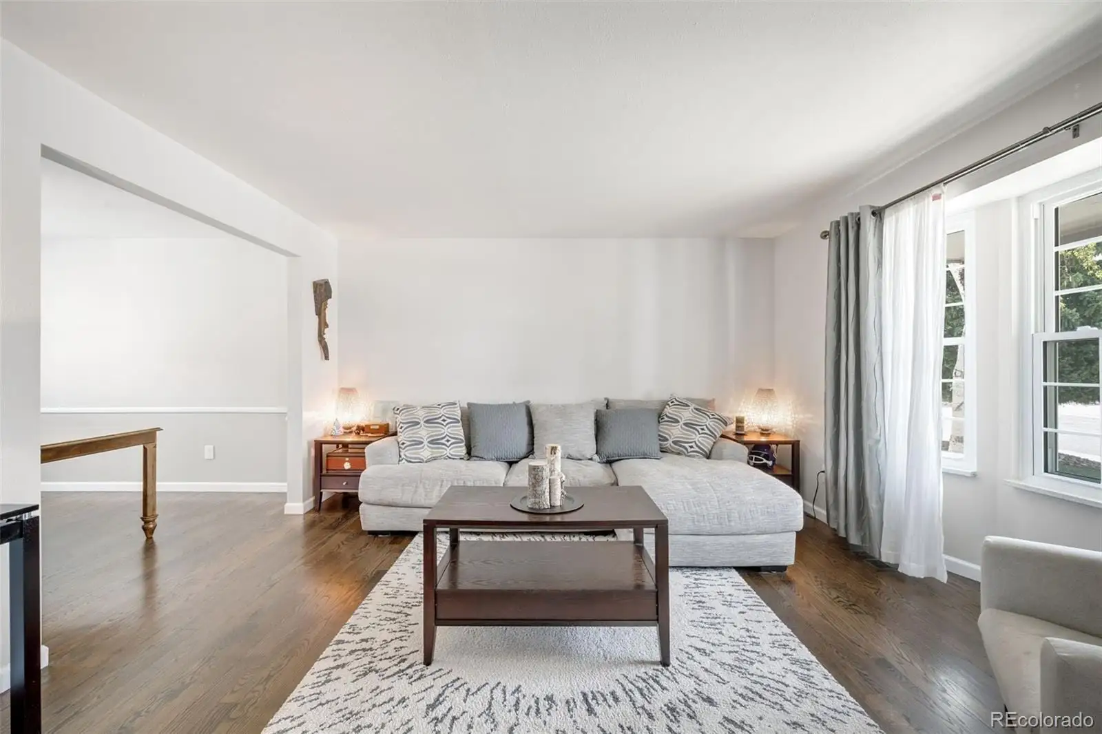 A living room with furniture and a table at 12945 East Colorado Avenue