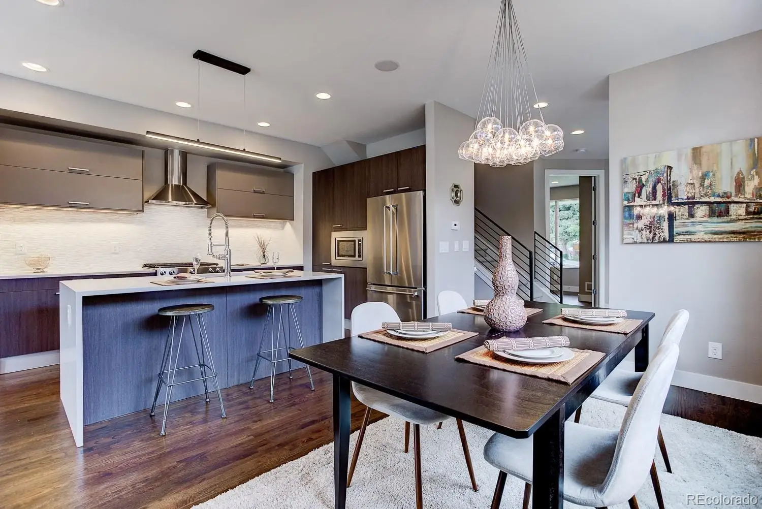 A view of a dining room with furniture a chandelier and wooden floor at 2851 South Cherokee Street