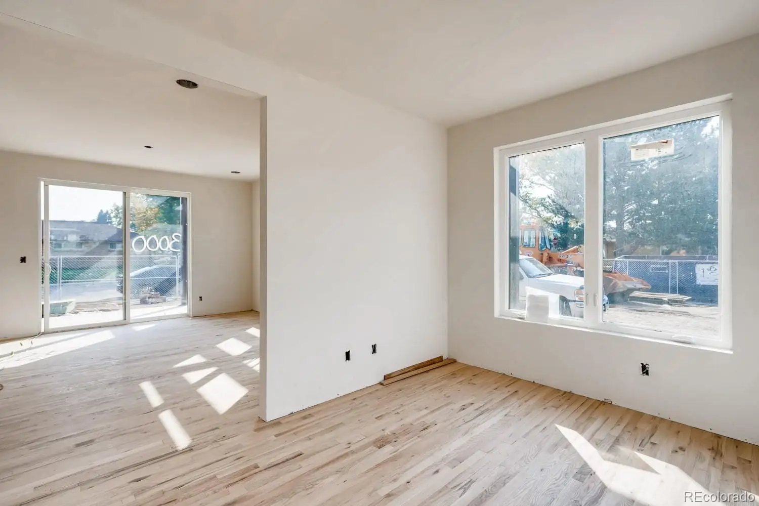 A view of an empty room with wooden floor and a window at 1001 Newport Street
