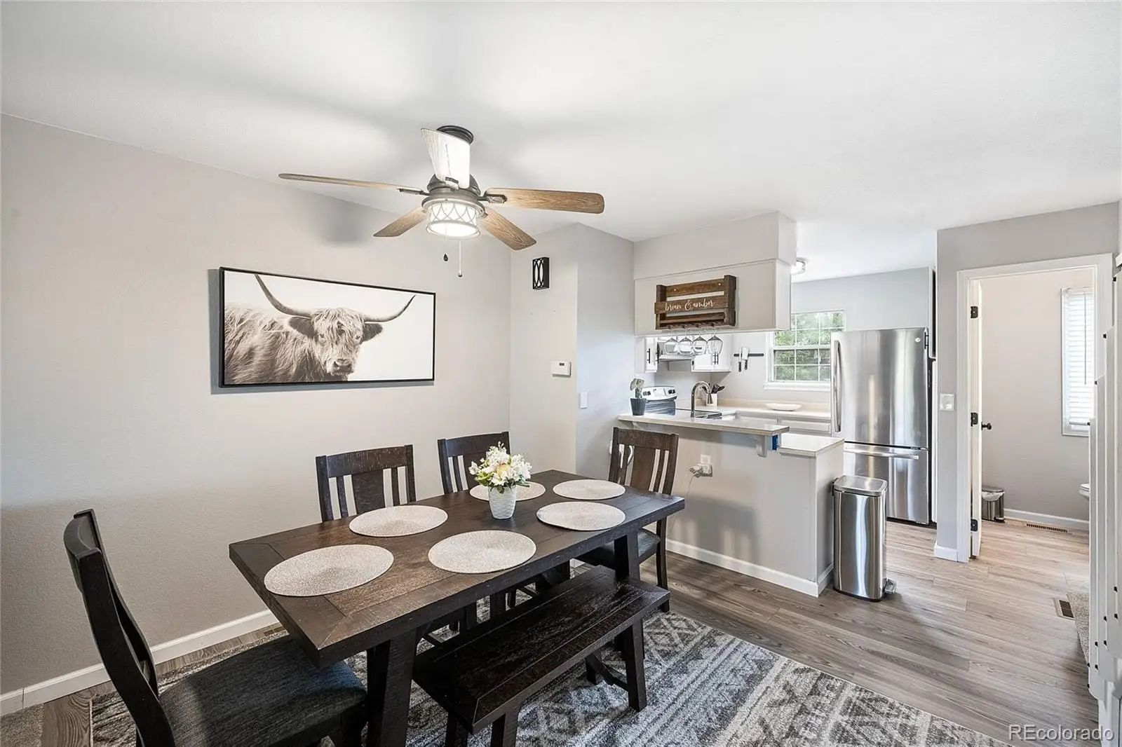 A view of a dining room with furniture and a chandelier at 8135 South Fillmore Circle