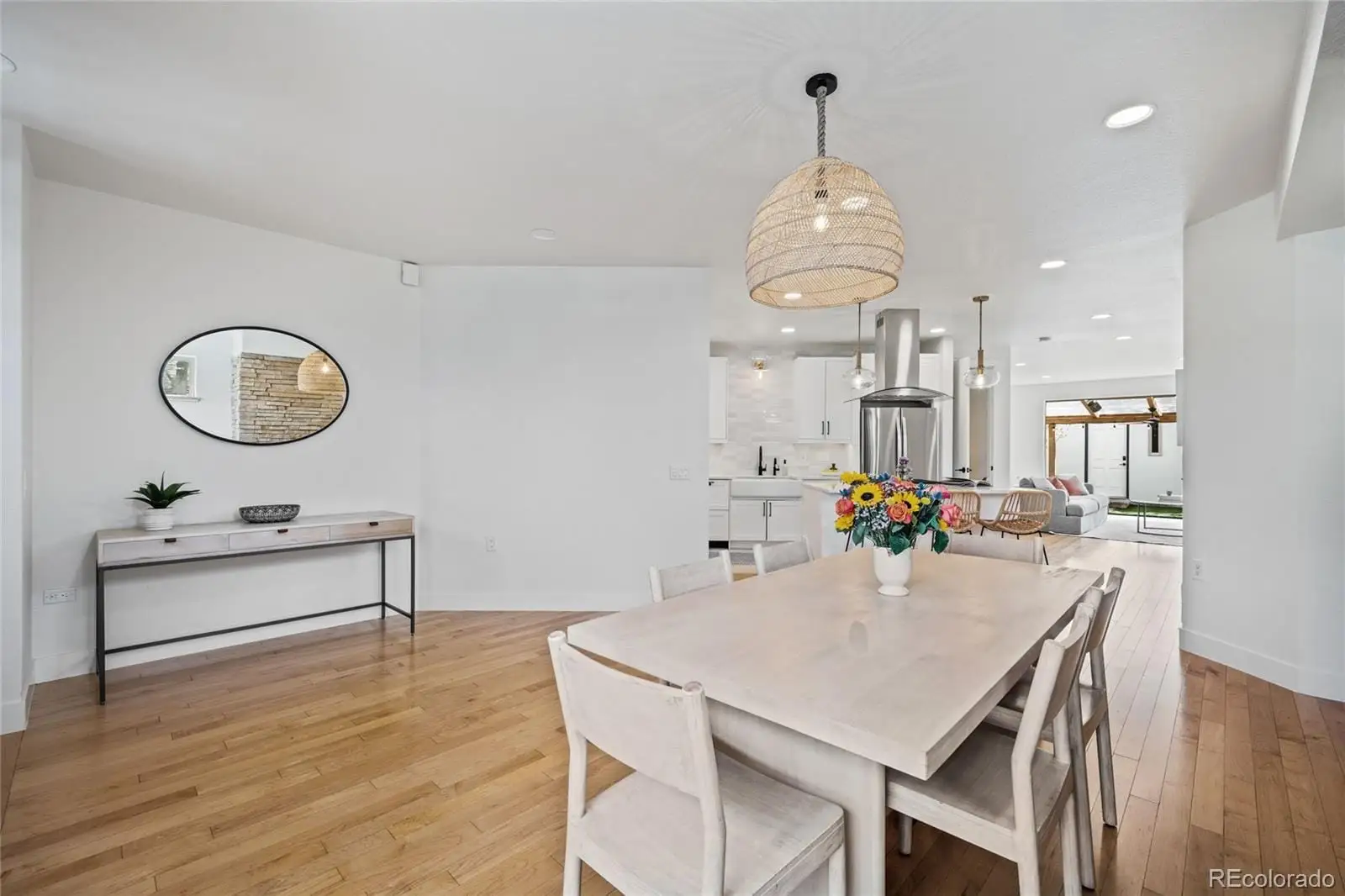 A view of a dining room with furniture and wooden floor at 4560 West 35th Avenue