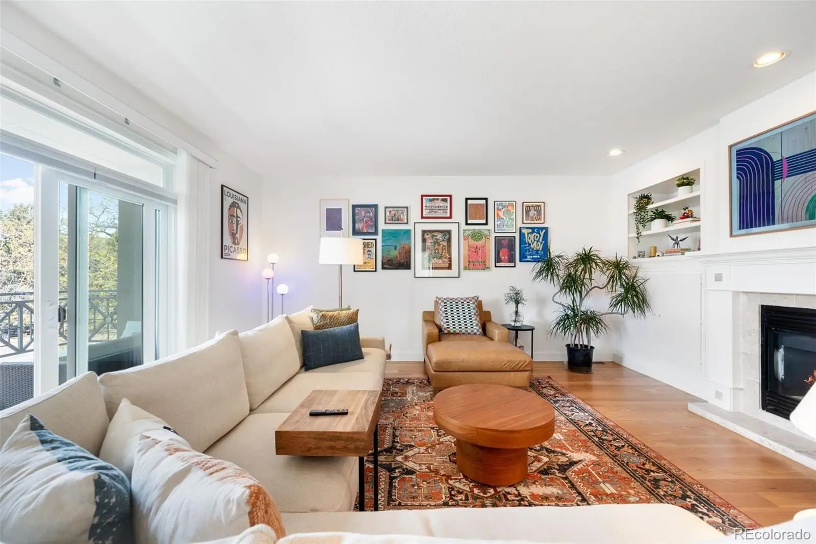 A living room with furniture and a fireplace at 234 South Madison Street, Unit H