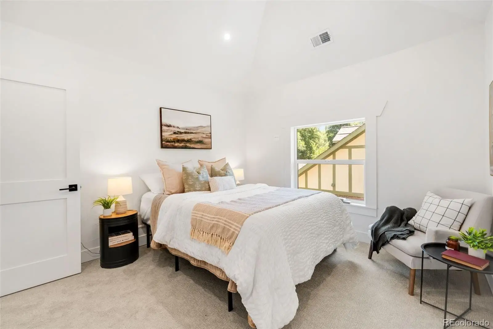 A bedroom with a bed and a window at 2343 Dahlia Street