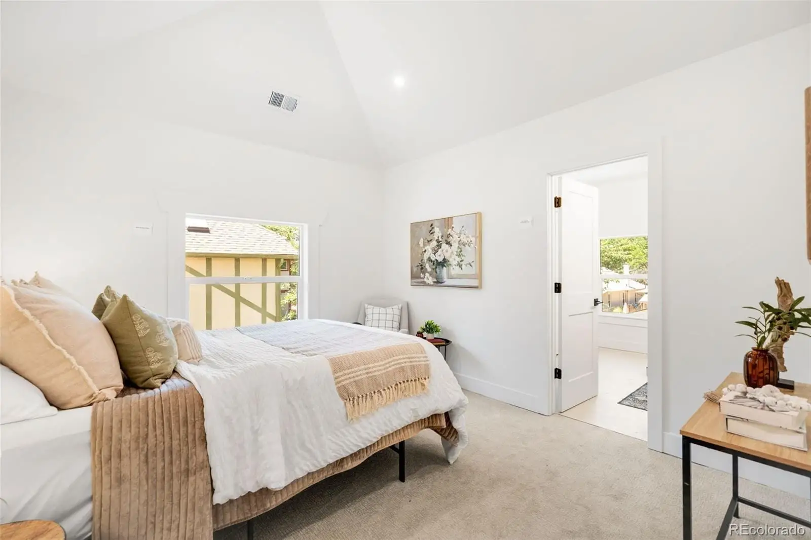 A bedroom with a bed and painting on the wall at 2343 Dahlia Street