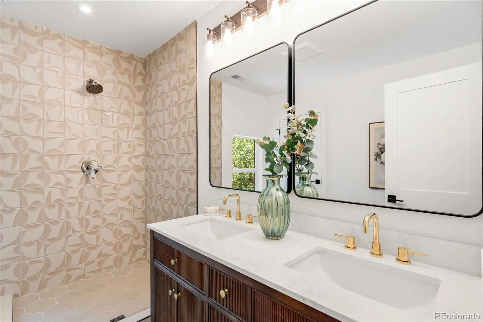 A bathroom with a granite countertop sink a potted plant and a mirror at 2343 Dahlia Street