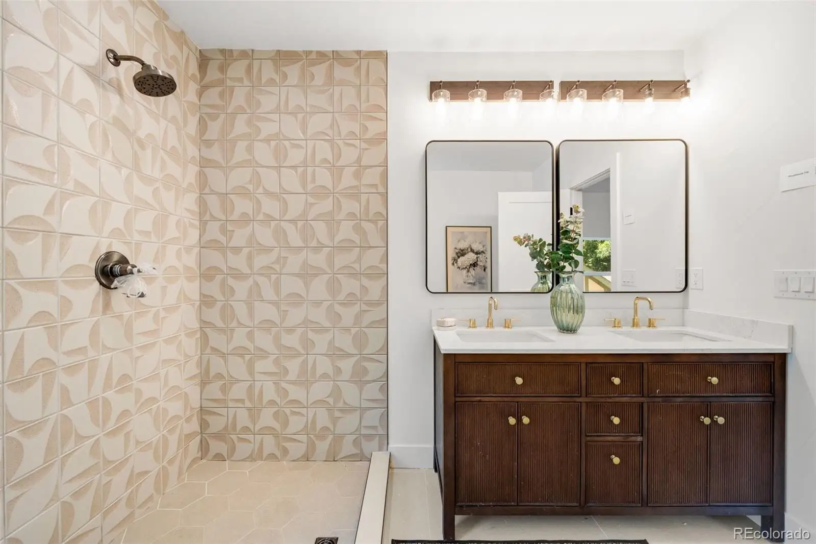 A bathroom with a double vanity sink mirror and shower at 2343 Dahlia Street