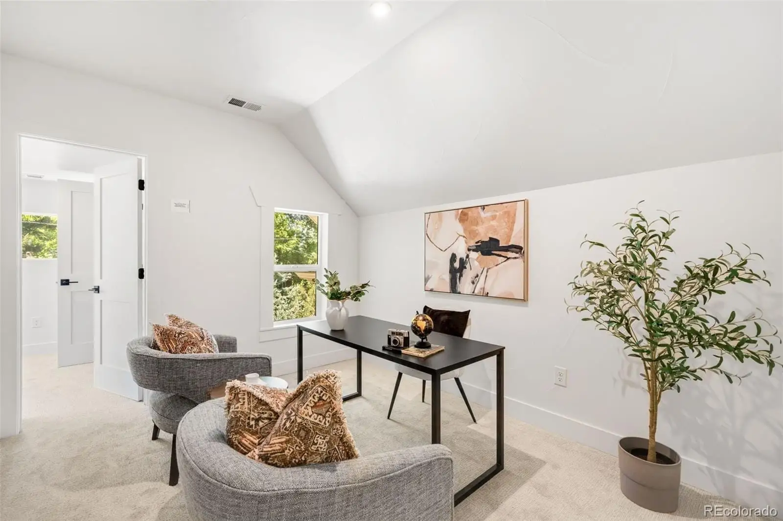 A living room with furniture and a potted plant at 2343 Dahlia Street