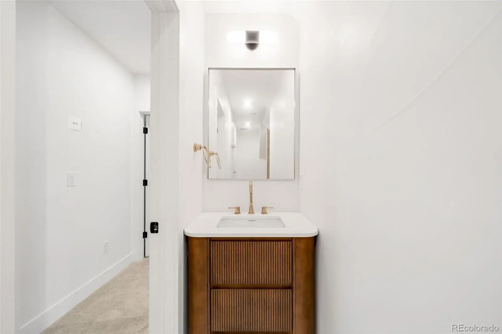 A bathroom with a sink and a mirror at 2343 Dahlia Street